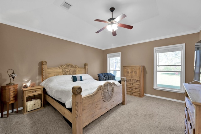 bedroom featuring crown molding, baseboards, visible vents, and light carpet