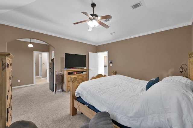 bedroom with visible vents, baseboards, light colored carpet, ornamental molding, and arched walkways