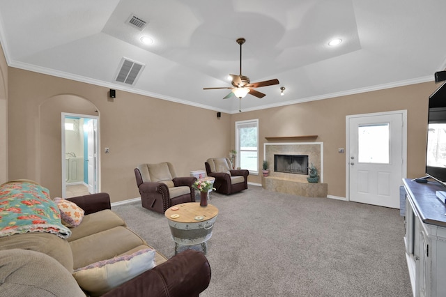 living area featuring a wealth of natural light, visible vents, and carpet