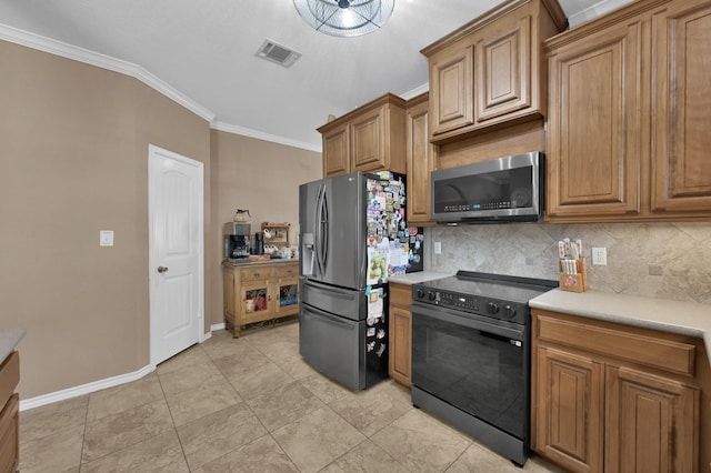 kitchen with visible vents, light countertops, appliances with stainless steel finishes, crown molding, and backsplash