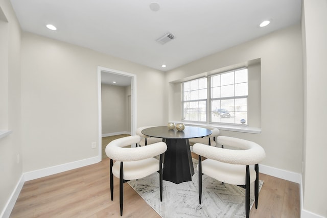 dining area featuring light wood-type flooring, baseboards, visible vents, and recessed lighting