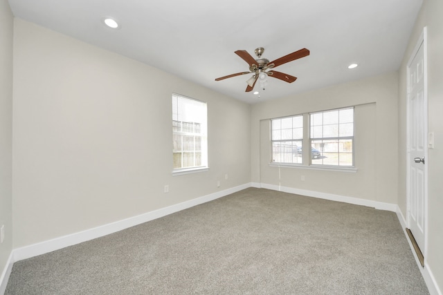 spare room featuring carpet, baseboards, and recessed lighting