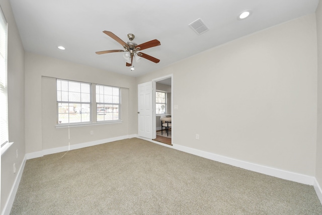 carpeted spare room featuring ceiling fan, recessed lighting, visible vents, and baseboards