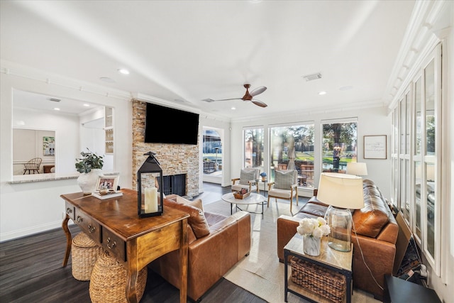 living area featuring dark wood-type flooring, visible vents, crown molding, and a fireplace