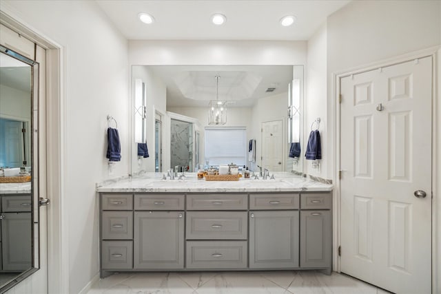 full bath featuring marble finish floor, double vanity, and a stall shower