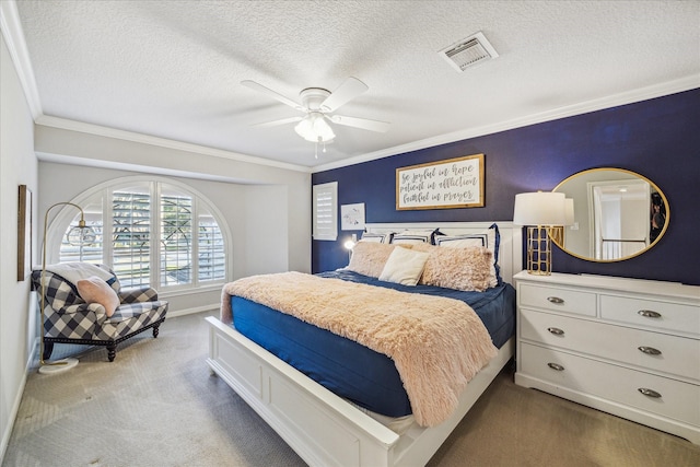 carpeted bedroom with visible vents, crown molding, a textured ceiling, and ceiling fan