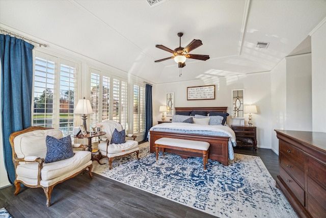 bedroom with visible vents, ceiling fan, vaulted ceiling, wood finished floors, and baseboards