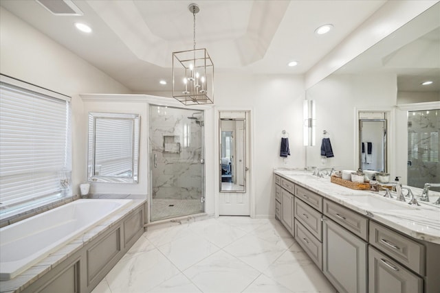 bathroom with marble finish floor, a marble finish shower, a garden tub, and a sink