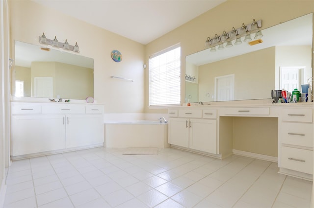 bathroom featuring tile patterned flooring, two vanities, a sink, and a bath