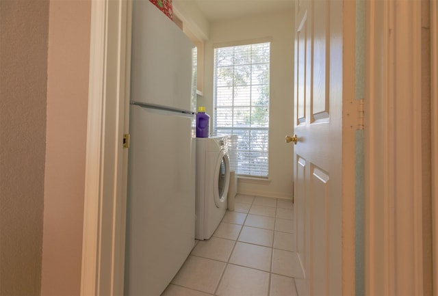 laundry area with laundry area, light tile patterned floors, and washer / dryer