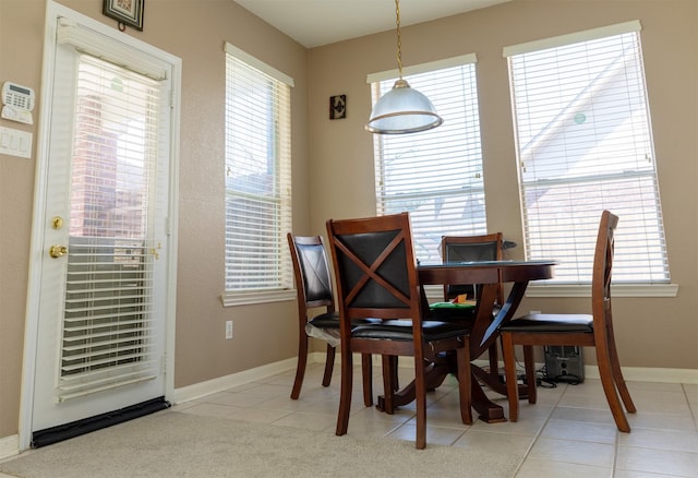 dining area with baseboards and light tile patterned flooring