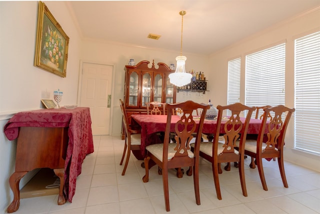 dining space with ornamental molding and visible vents