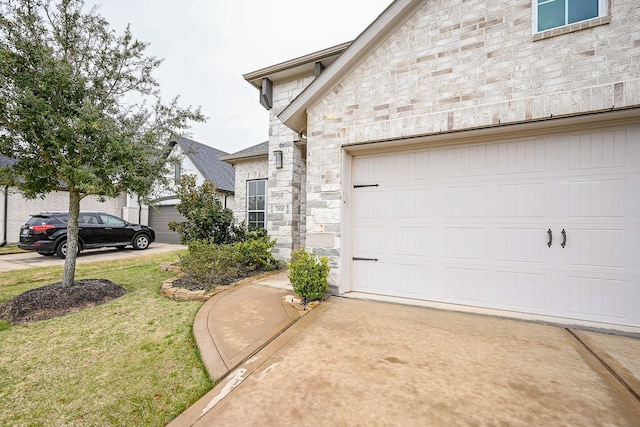 exterior space with a garage, stone siding, and a lawn