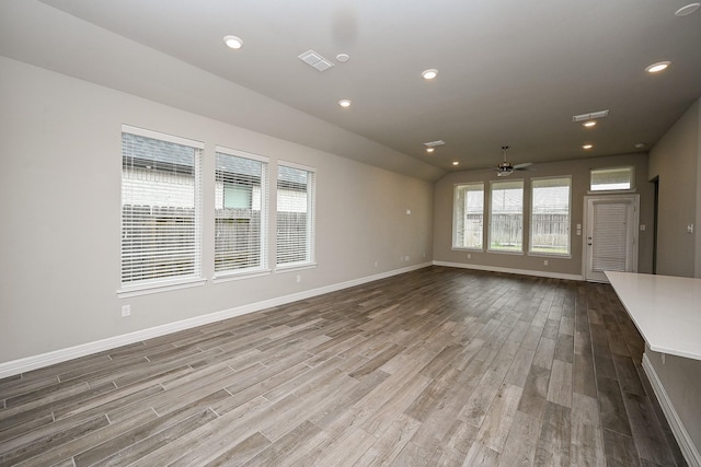 unfurnished living room featuring recessed lighting, visible vents, ceiling fan, wood finished floors, and baseboards