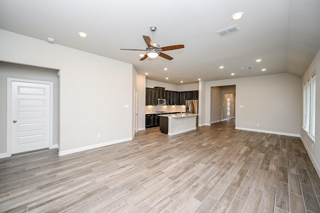 unfurnished living room featuring recessed lighting, visible vents, light wood-style flooring, ceiling fan, and baseboards