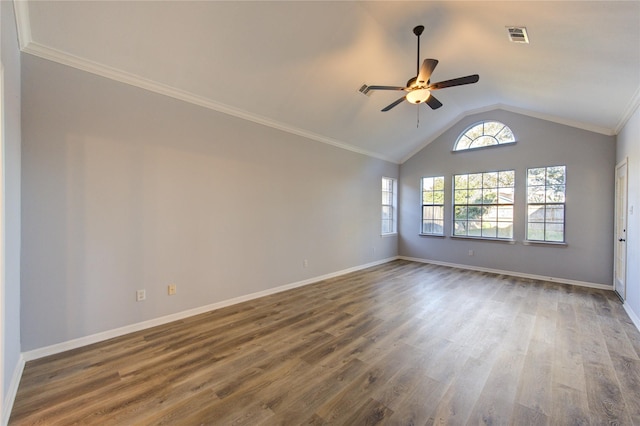 spare room featuring lofted ceiling, baseboards, visible vents, and wood finished floors