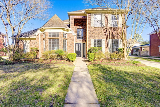 view of front of house with brick siding and a front lawn