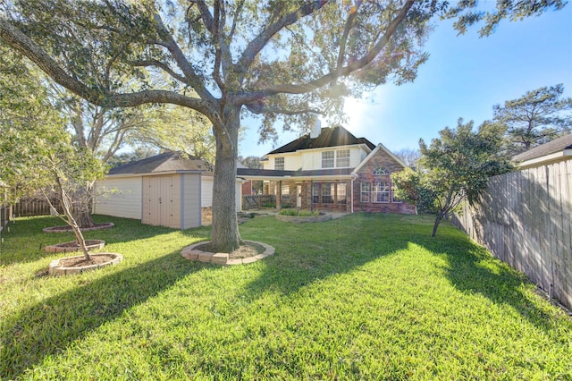 view of yard featuring a fenced backyard, a storage unit, and an outdoor structure