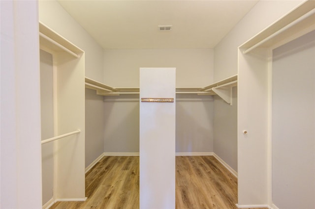 walk in closet featuring visible vents and wood finished floors