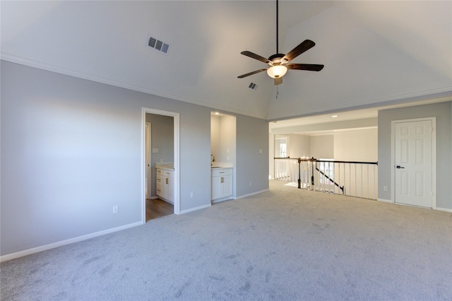 spare room featuring baseboards, visible vents, and light colored carpet