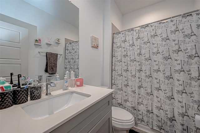 full bath with curtained shower, vanity, and toilet