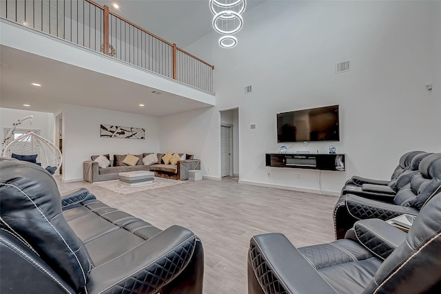 living room with wood finished floors, visible vents, and baseboards