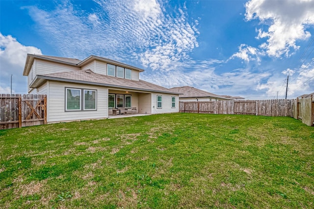 rear view of property featuring a fenced backyard, a yard, and a patio