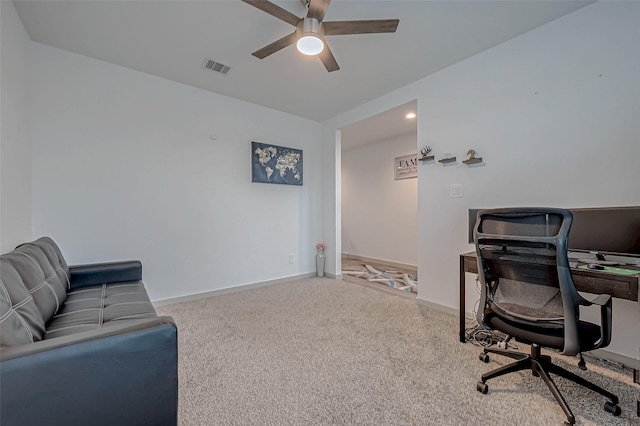 carpeted office featuring a ceiling fan, visible vents, and baseboards