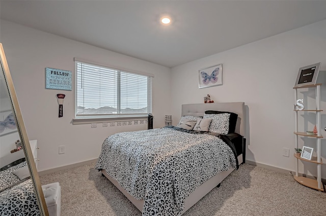 carpeted bedroom featuring baseboards