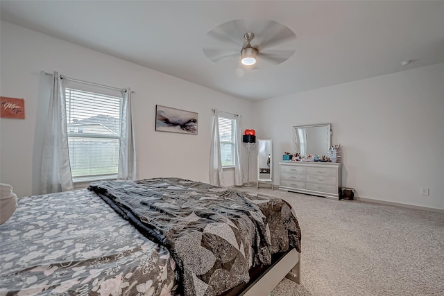 carpeted bedroom featuring ceiling fan and baseboards