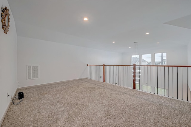 spare room featuring carpet floors, baseboards, visible vents, and recessed lighting