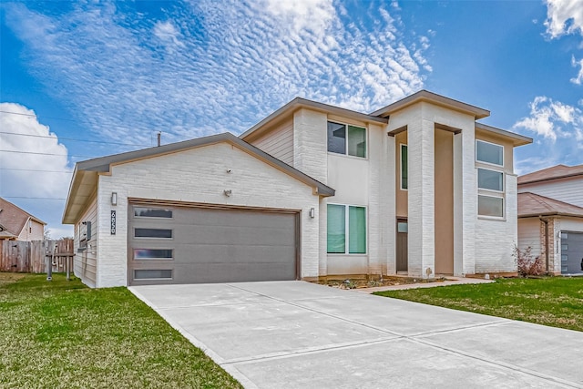 view of front of home featuring a garage, concrete driveway, a front yard, and fence