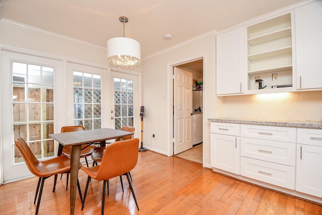 dining space featuring crown molding, light wood-style floors, baseboards, and french doors