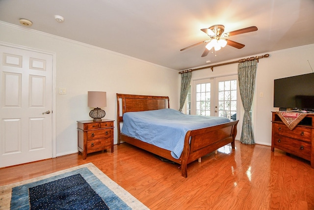 bedroom featuring light wood-type flooring, access to outside, crown molding, and french doors