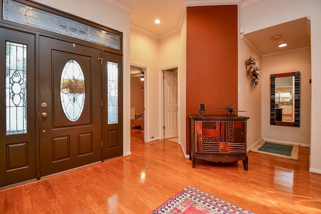 entryway with recessed lighting, baseboards, wood finished floors, and crown molding