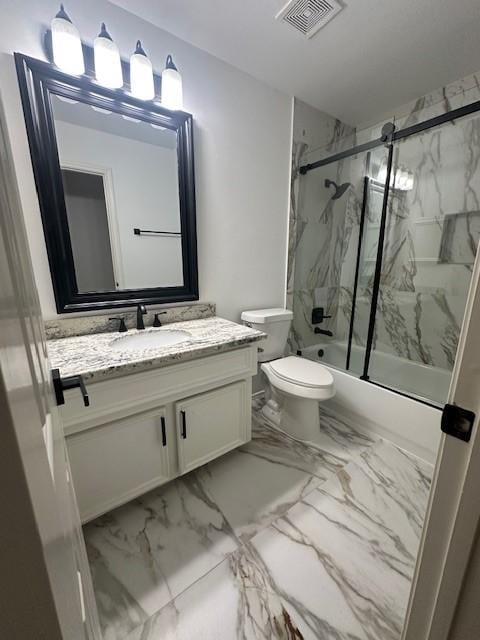 bathroom featuring toilet, vanity, visible vents, marble finish floor, and combined bath / shower with glass door