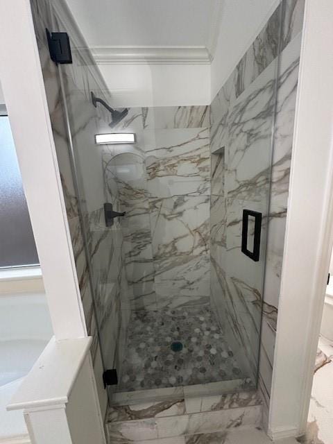 full bathroom featuring marble finish floor, a marble finish shower, and crown molding