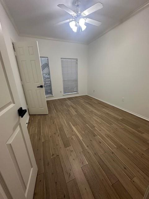 unfurnished bedroom with ornamental molding, baseboards, hardwood / wood-style floors, and a ceiling fan