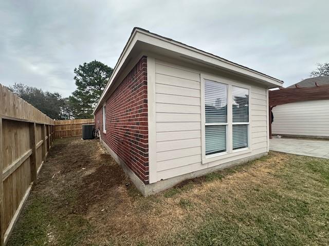 view of property exterior featuring a patio area, a fenced backyard, and cooling unit