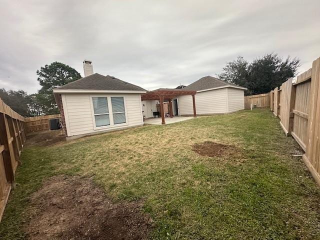 back of house featuring a patio, a chimney, a lawn, central AC unit, and a fenced backyard