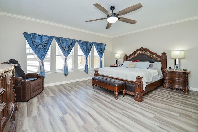 bedroom featuring baseboards, crown molding, and light wood-style floors