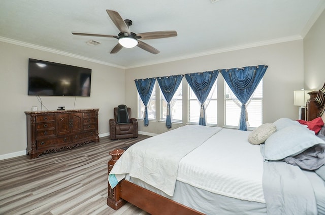 bedroom with ornamental molding, visible vents, and baseboards