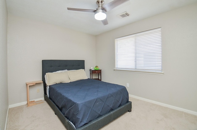 carpeted bedroom featuring ceiling fan, visible vents, and baseboards