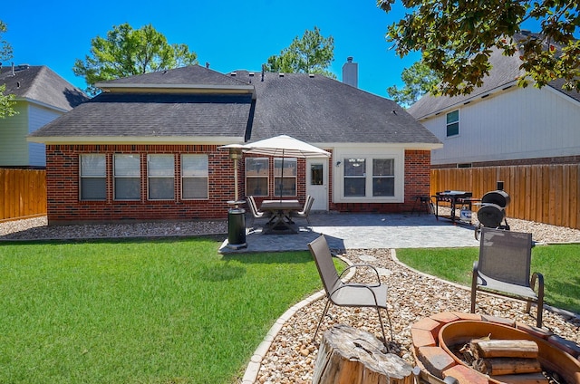 back of house featuring a fire pit, a patio, and brick siding