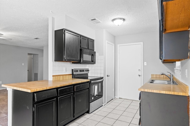 kitchen featuring black microwave, a sink, visible vents, dark cabinetry, and stainless steel electric range