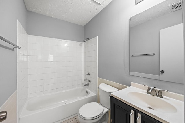 full bathroom featuring visible vents, a textured ceiling, toilet, and vanity