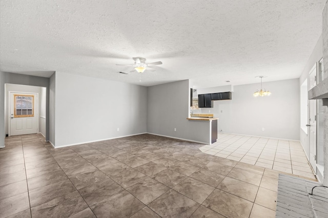 unfurnished living room with tile patterned flooring, visible vents, a textured ceiling, and ceiling fan with notable chandelier