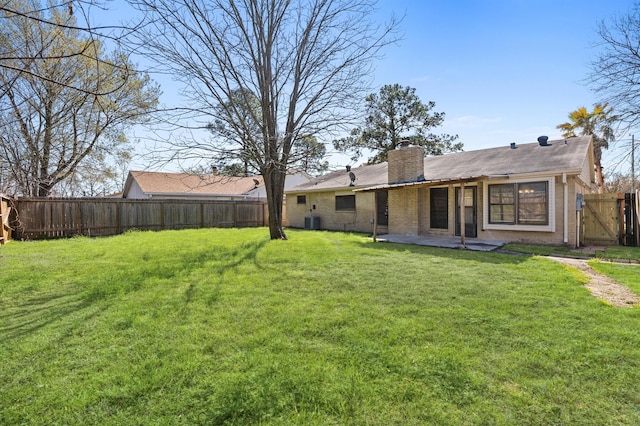 view of yard with central air condition unit, a gate, fence, and a patio