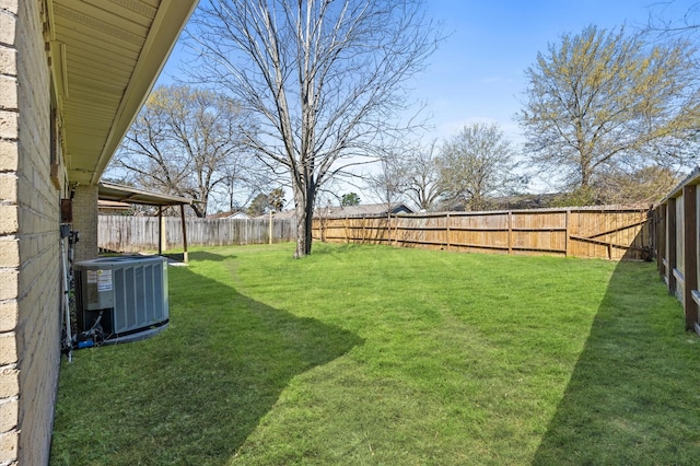 view of yard featuring a fenced backyard and central air condition unit