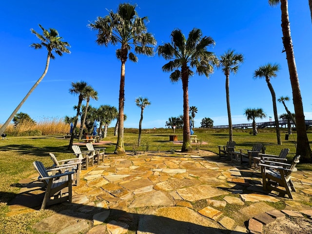 surrounding community featuring a yard and a patio